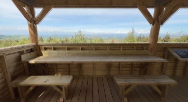 Hand-built timber bench and table inside the Forestry England shelter at Haldon Forest Park, built by 4orty Construction