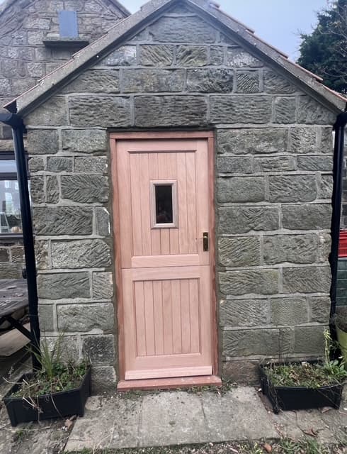 Bespoke timber stable-style door fitted to a stone outbuilding by 4orty Construction
